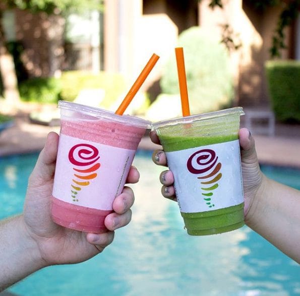 A vibrant Jamba Food Truck serving fresh fruit smoothies and juices at an outdoor corporate wellness event.