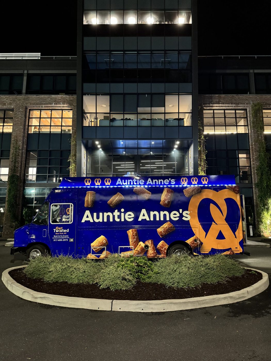 Snack City NYC food truck at a corporate headquarters at night