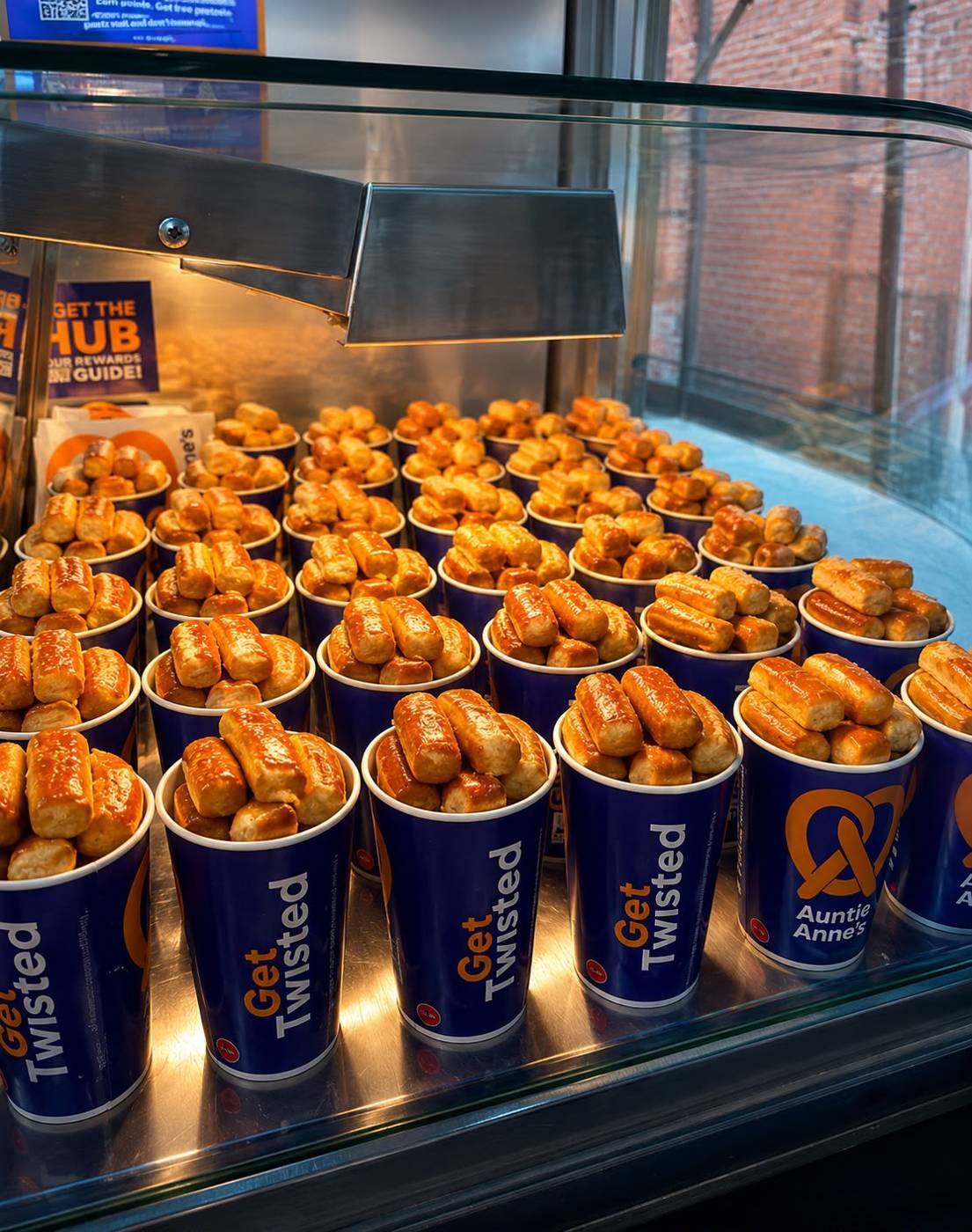 Fresh pretzel nugget cups lined up in the Snack City NYC serving window