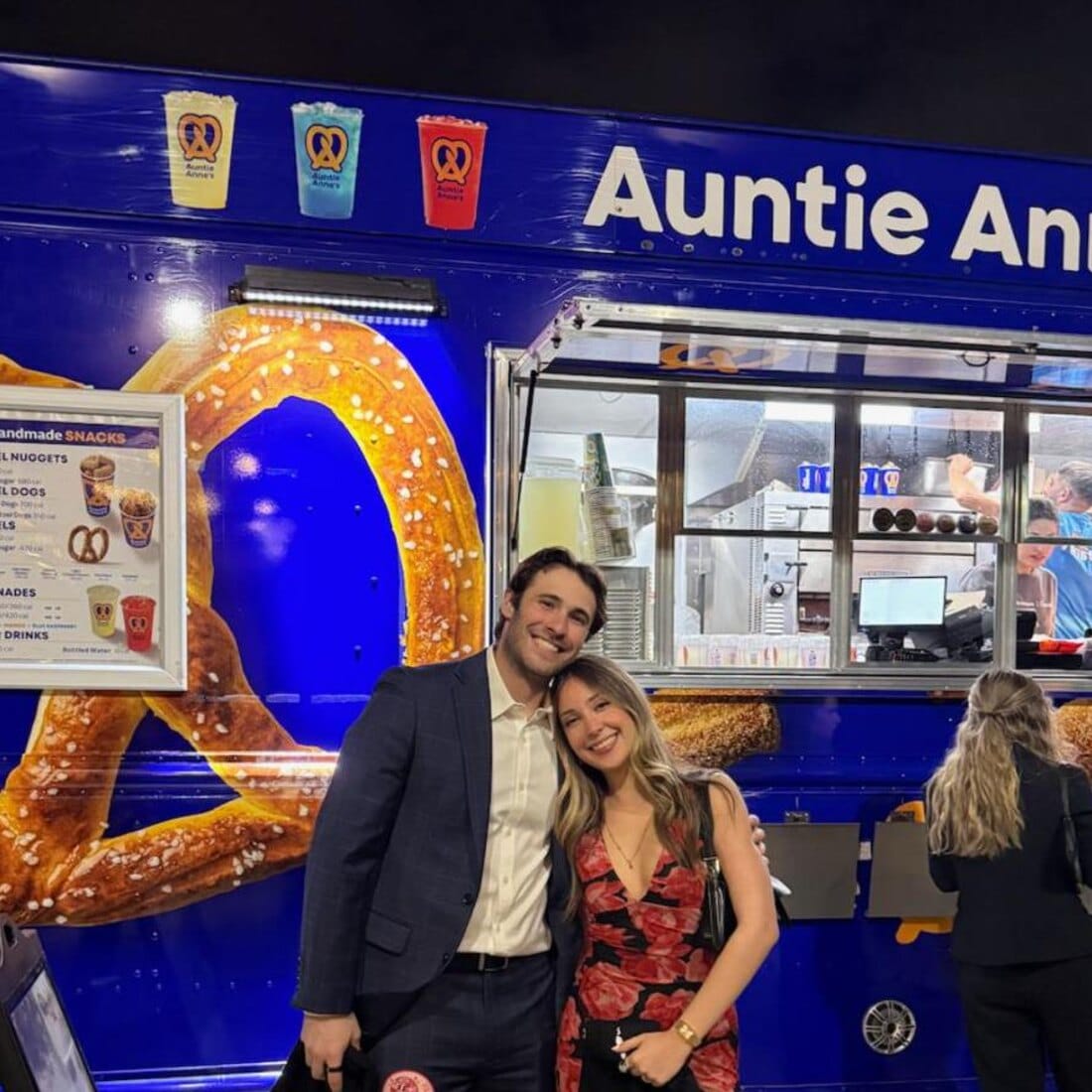 Guests at an evening B+ Foundation event beside the Snack City NYC Auntie Anne’s truck
